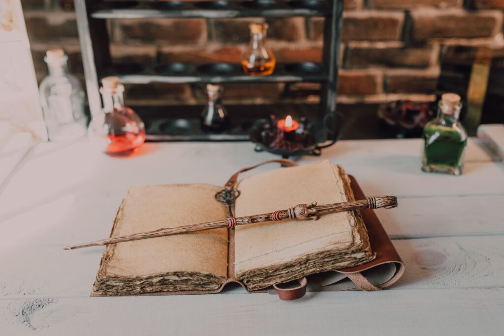Magical close-up of a wand on an ancient spell book with potions.